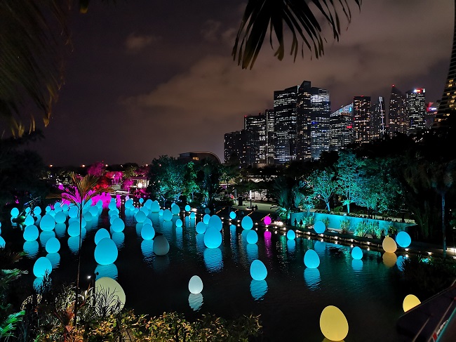 singapore by night with the glowing eggs on the water and the skyline