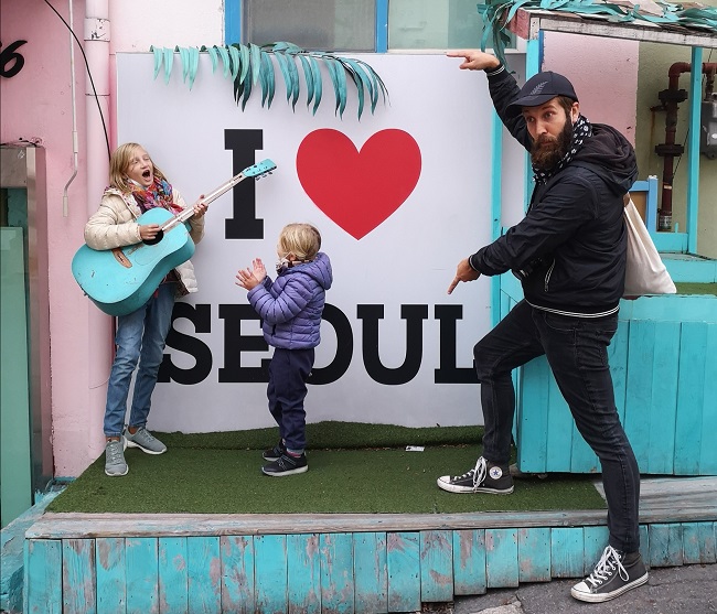 In front of We Love Seoul piece with a blue guitar in Ihwa-Dong 